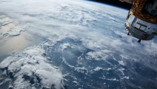 An image of the earth from space, plus a satellite